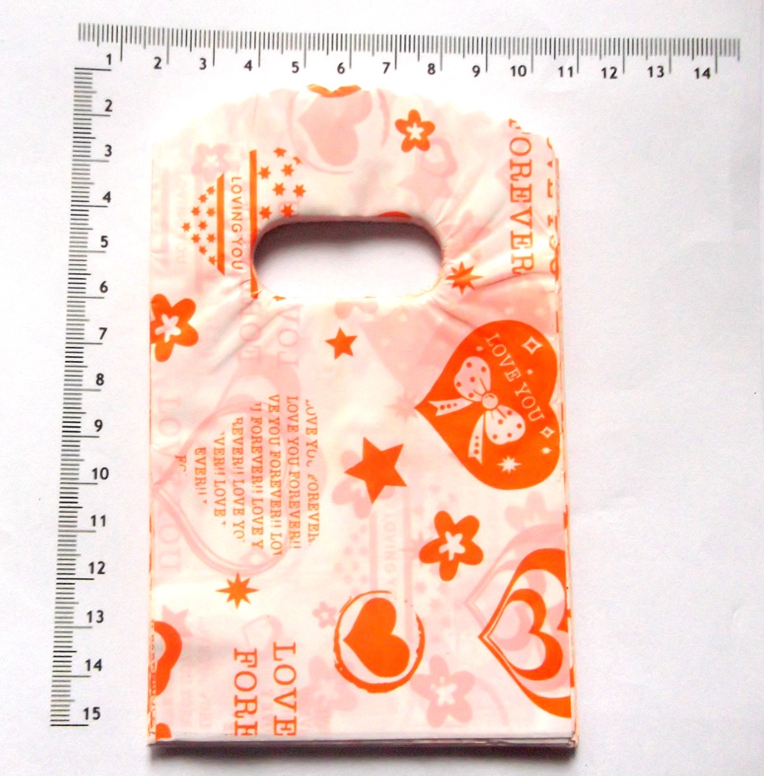 Punguta plastic de cadou cu cu inimioare portocalii 44376 - crăciun - accesorii cadou de crăciun - hârtii de ambalat cadouri - Artynos.ro